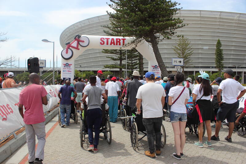 Wheelchair users and supporters at the start line of the wheelchair fun ride